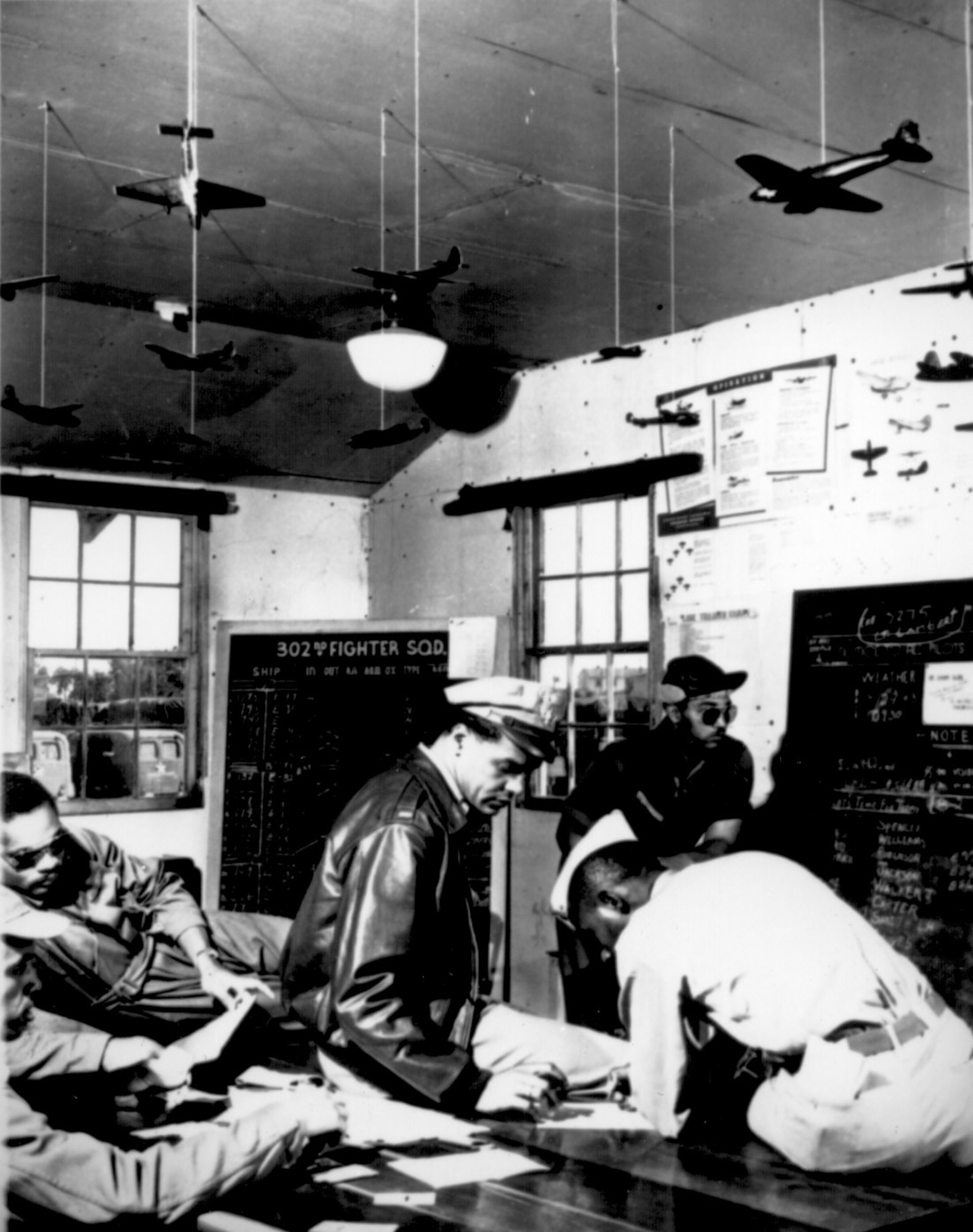 Pilots are briefed for a bombing raid during their training at Selfridge Field, Mich., 1943.