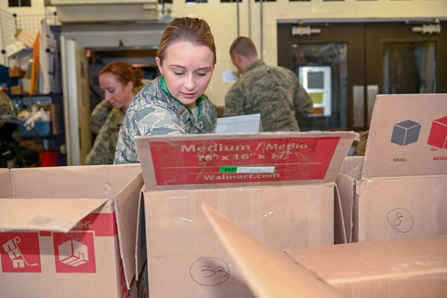 2nd Lt. Alexa Reed, volunteering chairperson Company Grade Officer’s Council, prepares troop care packages during a Troop Care Drive at the Minuteman Thrift Shop Jan. 16. The packages, headed  to Hanscom members serving overseas, each contain a number of smaller care packs for the member to share with their deployed units. (U.S. Air Force photo by Mark Herlihy)