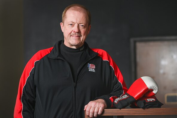 Gregory Leschishin, 66th Force Support Squadron Information, Tickets and Tours manager, poses for a photo with his boxing gloves on Hanscom Air Force Base, Mass., Jan. 16.  Leschishin has been involved with amateur, Olympic-style boxing for more than 45 years and will host a boxing class at the Fitness and Sports Center on base. (U.S. Air Force photo by Todd Maki)