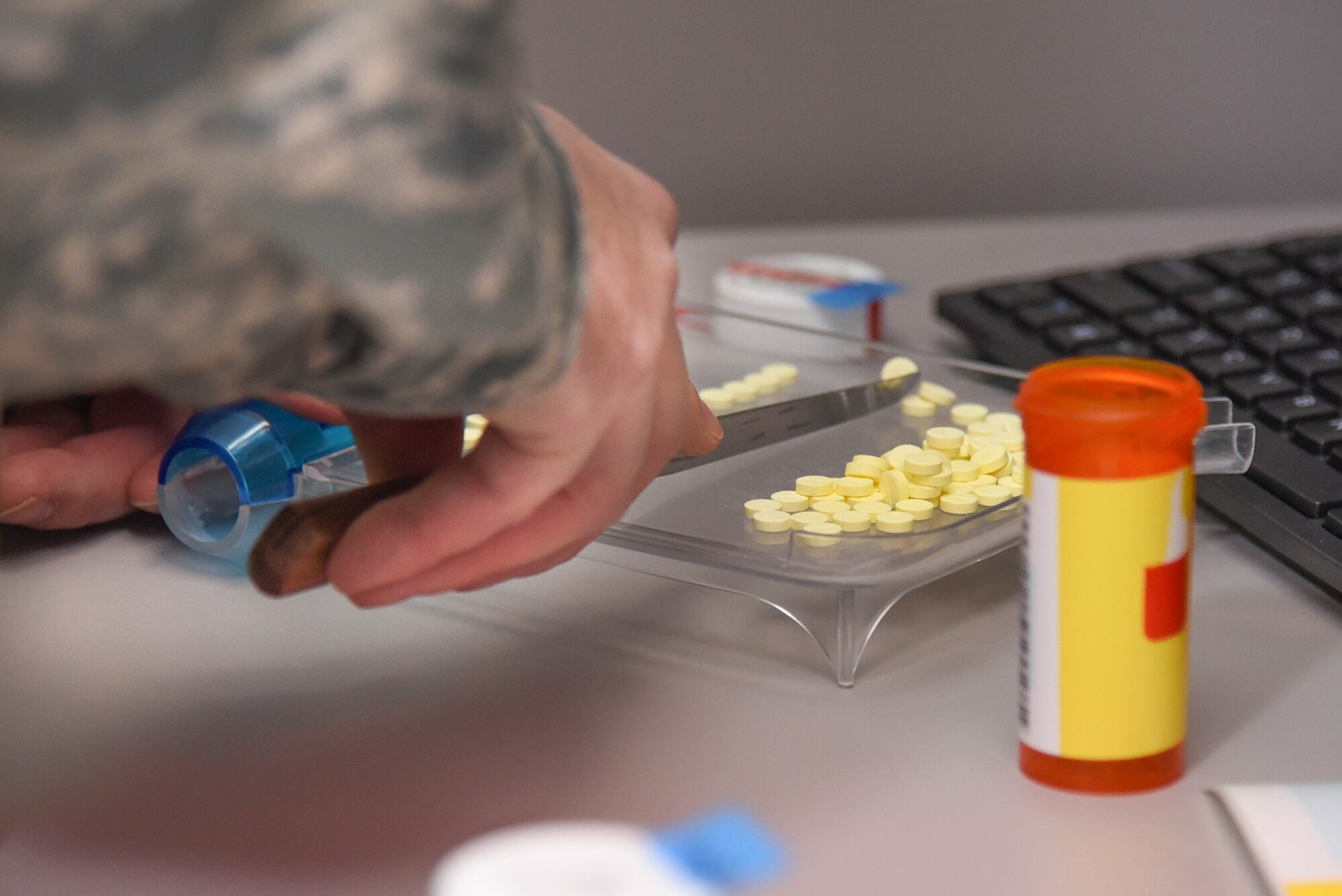 Staff Sgt. Jeff Duerson, 66th Medical Squadron pharmacy vault custodian, counts prescribed tablets before packaging them on Hanscom Air Force Base, Mass., Jan. 8. The pharmacy will be operating under limited capabilities Feb. 18 through 21 and closed Feb. 24 through 25 while the facility undergoes renovations. (U.S. Air Force photo by Todd Maki)