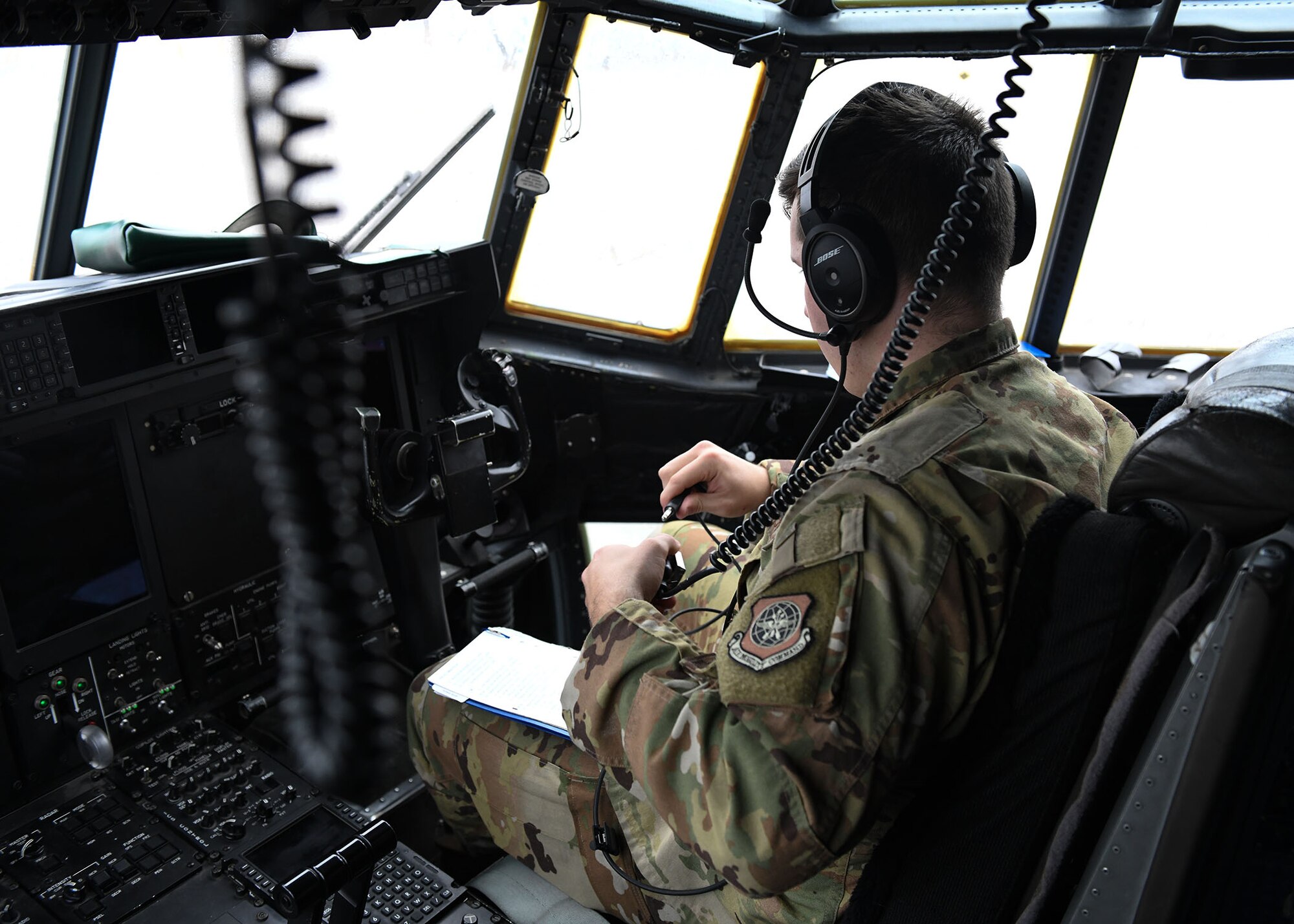 An Airmen sits on the flight-deck of a C-130.