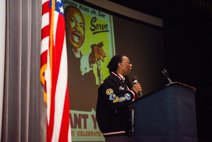 An Airman speaks during an MLK Jr. event.