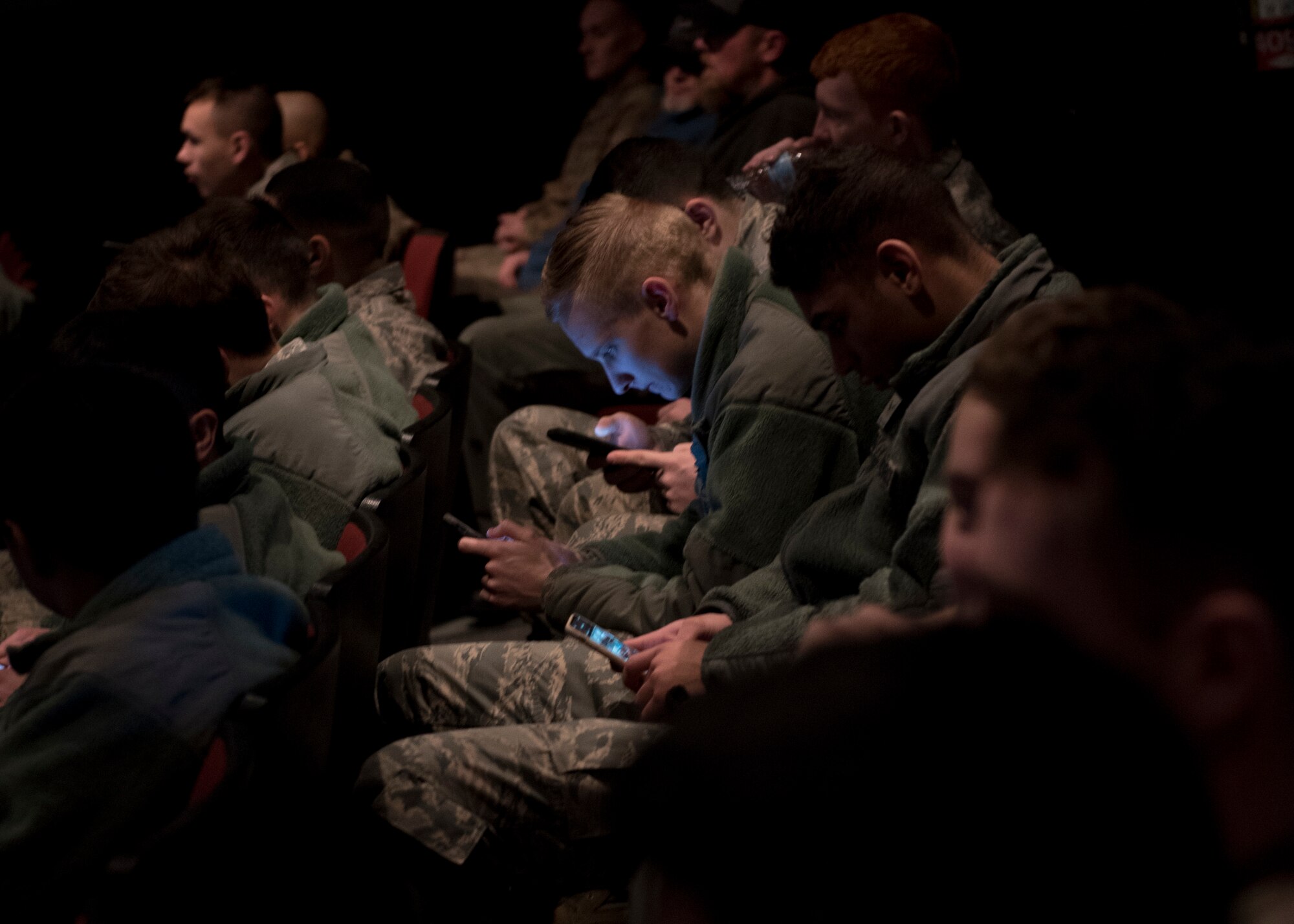 Airmen attending an all-call meeting connect to the online presentation via personal smart phones at Fairchild Air Force Base, Washington, Jan. 15, 2020. First pioneered at the base in 2017, connecting meeting attendees via smart devices helps commanders engage with large groups of Airmen in real time though polls, quizzes, feedback and questions. (U.S. Air Force photo by Staff Sgt. Ryan Lackey)