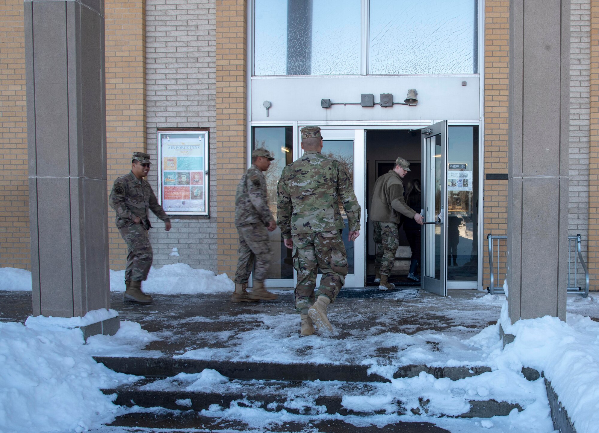 Team Fairchild Airmen enter the base theater to attend an all-call meeting at Fairchild Air Force Base, Washington, Jan. 15, 2020. All-call meetings are held to help ensure commander messages are relayed to as many base personnel as possible and to provide feedback opportunities for Airmen. (U.S. Air Force photo by Airman Annabelle Kaiser)