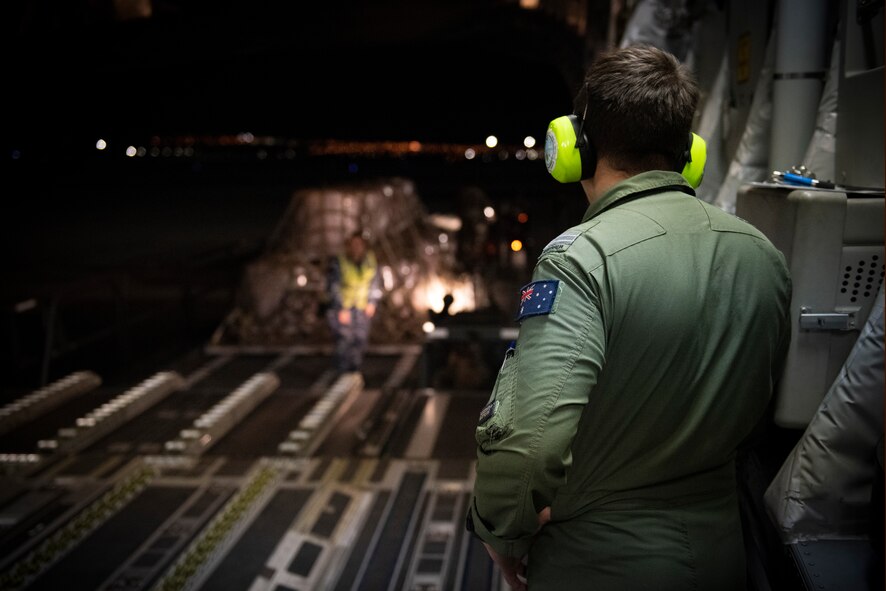 RAAF Airman watches aircraft being loaded.