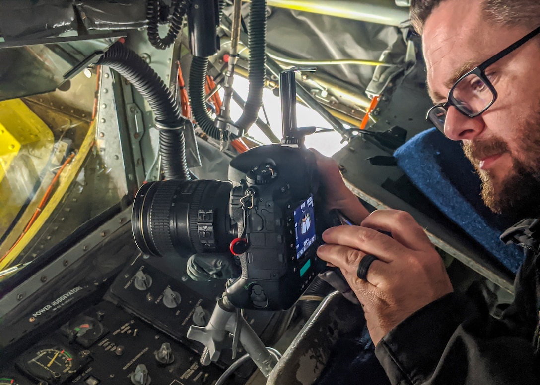 Ethan Wagner, 412th Test Wing aerial photographer, prepares his camera inside a KC-135 Stratotanker at Edwards Air Force Base, Jan. 17. The 412th Test Wing will send a KC-135 and three F-16 Fighting Falcons to conduct a flyover for the NFC championship game at Levi’s Stadium in Santa Clara, California, on Jan. 19. (Air Force photo by Crosby Shaterian)