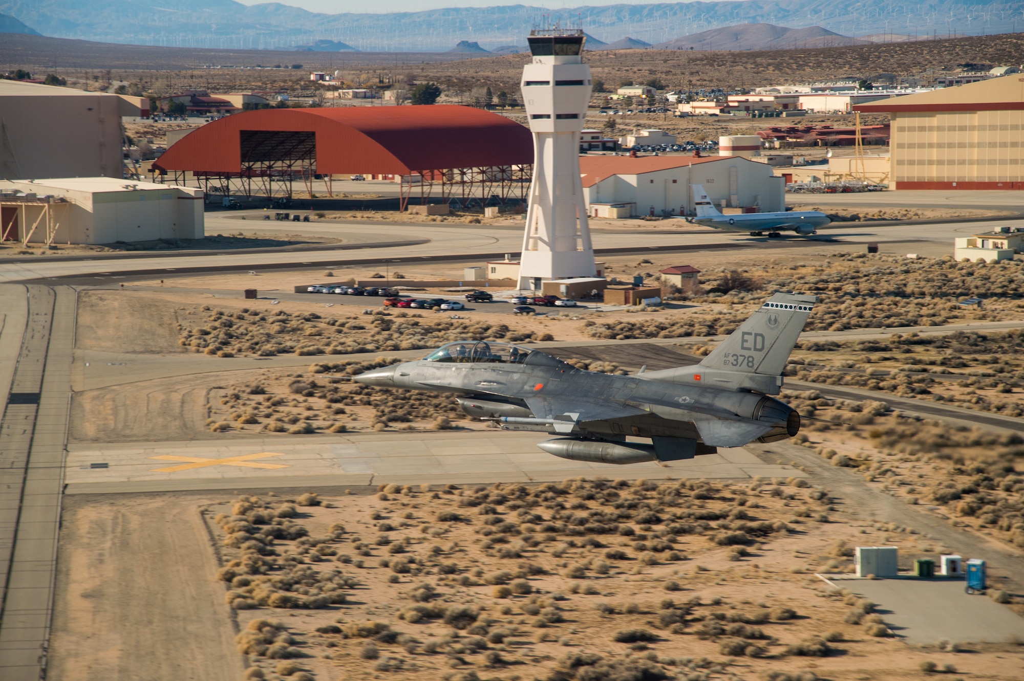 An F-16 Fighting Falcon from the 412th Test Wing’s 416th Flight Test Squadron performs a fly-by of the air control tower at Edwards Air Force Base, California, Jan. 10. The 412th Test Wing will send a KC-135 and three F-16 Fighting Falcons to conduct a flyover for the NFC championship game at Levi’s Stadium in Santa Clara, California, on Jan. 19. (Air Force photo by Ethan Wagner)
