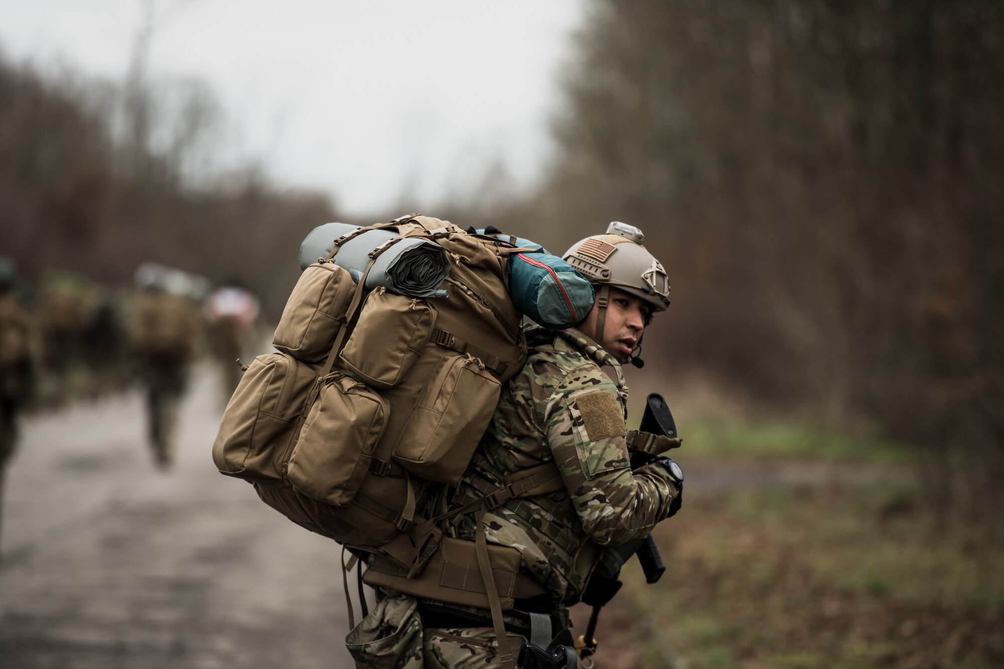 U.S. Air Force Tech. Sgt. Andrew Gibson, 435th Security Forces Squadron ground combat readiness training center course chief, pulls rear security while walking to a rally point during exercise Frozen Defender in Grostenquin, France, Jan. 14, 2020. Frozen Defender tests the squadron’s capabilities in a contested environment under harsh conditions. Volunteers from the 86th Security Forces Squadron participated in the exercise to provide opposition forces for the 435th SFS Defenders. The opposition forces concealed themselves in the wooded areas surrounding the site. (U.S. Air Force photo by Staff Sgt. Devin Boyer)