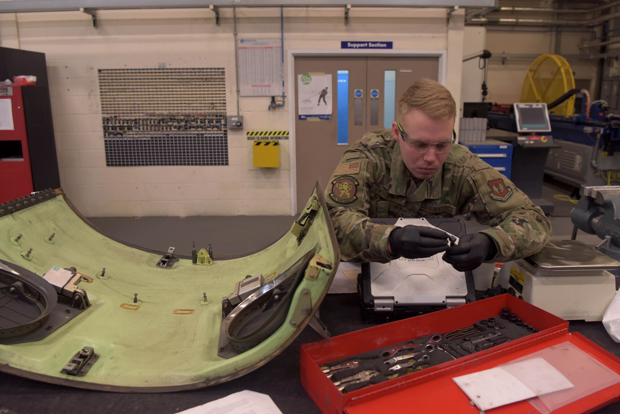 Senior Airman Chase Knipp, 100th Maintenance Squadron aircraft structural maintenance journeyman, grabs a tool from his toolbox at RAF Mildenhall, England, Jan. 14, 2020. The sheet metal shop, which also includes the corrosion control section, is responsible for the structural integrity of all of RAF Mildenhall’s assigned aircraft. (U.S. Air Force photo by Senior Airman Benjamin Cooper)