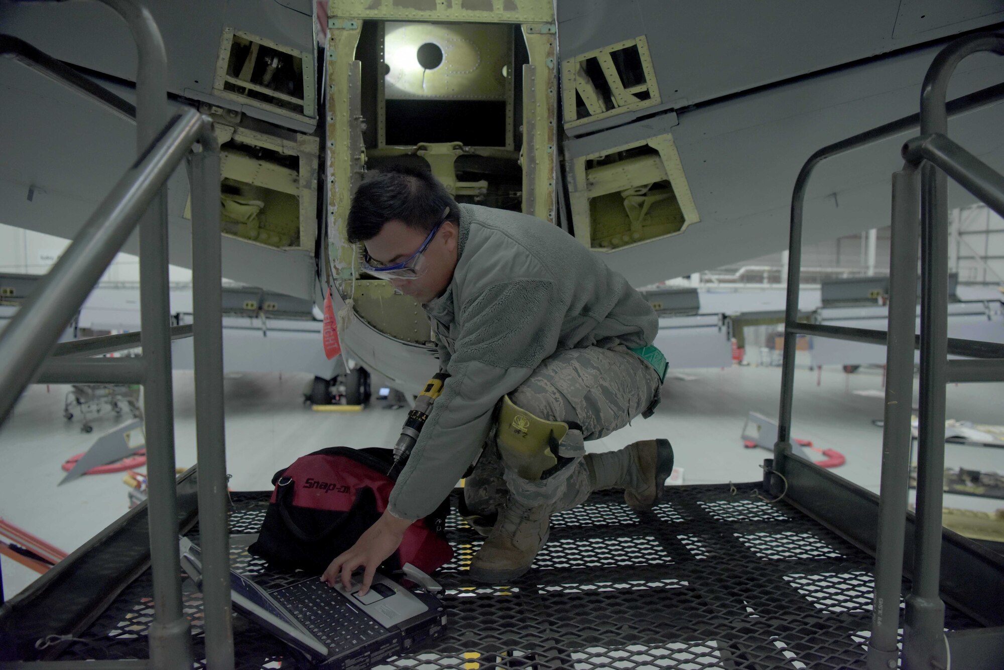 Airman 1st Class Robert Thach, 100th Maintenance Squadron aircraft structural maintenance journeyman, consults his technical orders prior starting repairs on a KC-135 Stratotanker at RAF Mildenhall, England, Jan. 14, 2020. The KC-135 has been in service for 60 years, in part due to the efforts of aircraft structural maintenance Airmen. (U.S. Air Force photo by Senior Airman Benjamin Cooper)