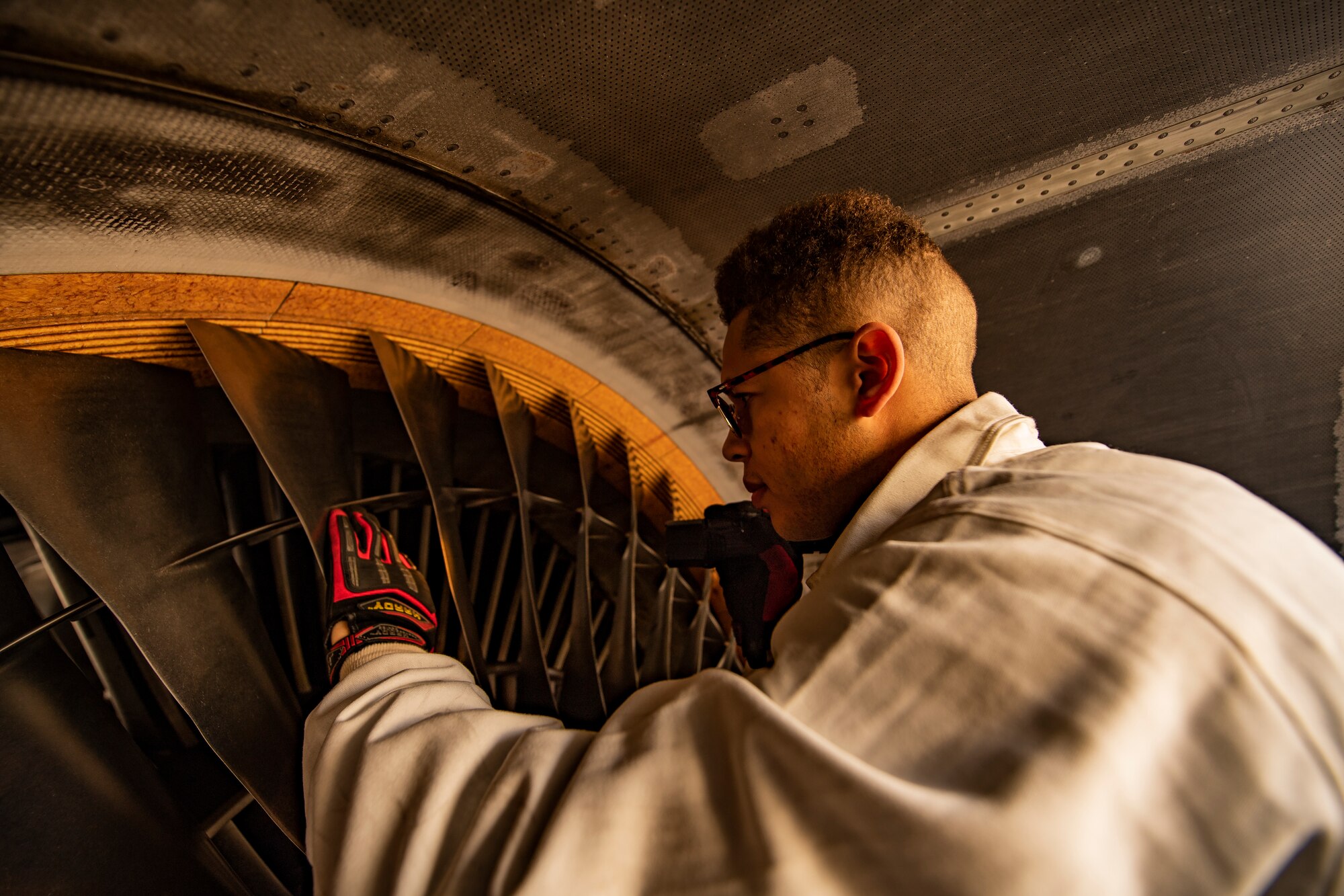 Senior Airman inspects engine blades for deficiencies before an eco-wash