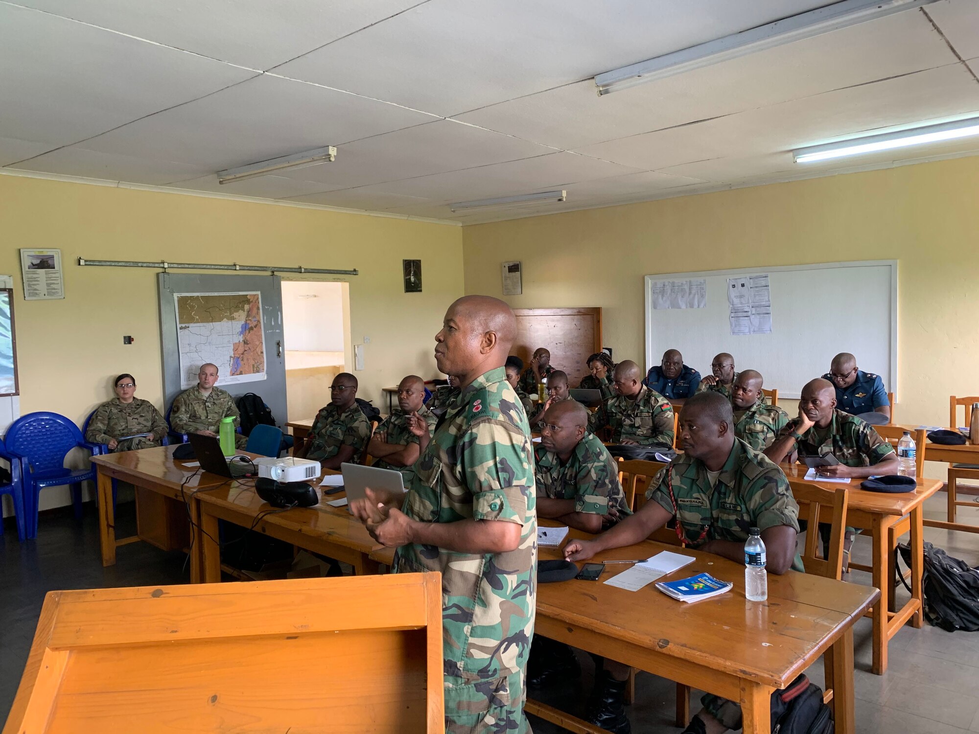 An Airmen from the Malawian air force briefs members of the U.S. Air Forces in Europe and Air Forces Africa Manpower, Personnel and Services Directorate, Force Development team at Lilongwe Air Base, Malawi, Jan. 14, 2020. The USAFE-AFAFRICA force development team has been working with the Malawian air force since 2018 to build partnership capacity in the region. (U.S. Air Force photo by Capt. Korey Fratini)