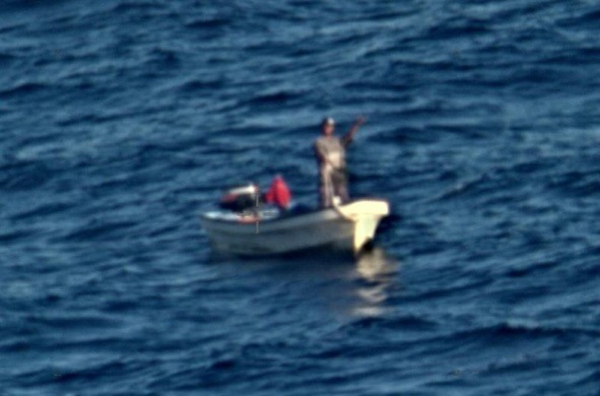 GUAM - A stranded fisherman waves to a P8A Poseidon aircraft conducting a Search and Rescue (SAR) of the coast of Guam.