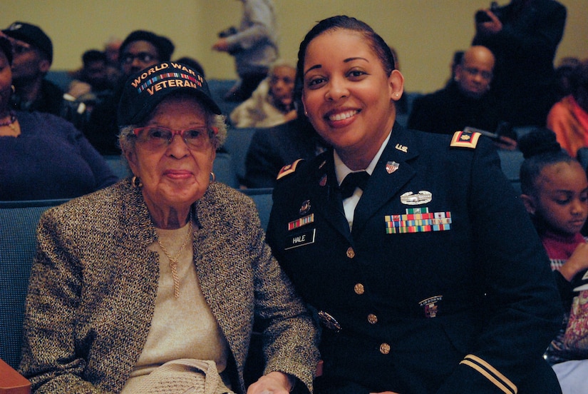 Maj. Lakisha Hale-Earle, chief of G1 plans and training for the U.S. Army Reserve’s 99th Readiness Division (right), pays tribute to former Sgt. Hilda P. Griggs, who served in the Second World War’s 6888th Central Postal Directory Battalion (left), during New Jersey’s annual Martin Luther King Jr. commemoration Jan. 19 at the N.J. State Museum Auditorium in Trenton. The 6888th was the first-and-only all-African American, all-female unit to deploy overseas during the war. It consisted of 855 women under the command of Lt. Charity Adams, the first African-American woman commissioned in the Women’s Army Corps.