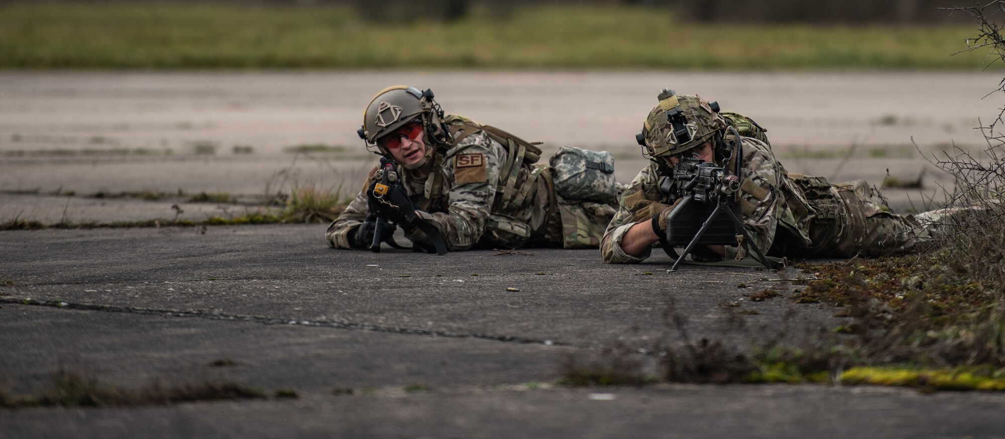 U.S. Air Force Staff Sgt. Esteban Goniwicha, 435th Security Forces Squadron ground combat readiness training center instructor, left, and Staff Sgt. Dwight Stalter, 435th SFS contingency response team leader, scan an airfield for threats during exercise Frozen Defender in Grostenquin, France, Jan. 14, 2020. Frozen Defender tests the squadron’s capabilities in a contested environment under harsh conditions. The Defenders were confronted with opposition forces to add realism to the scenario. (U.S. Air Force photo by Staff Sgt. Devin Boyer)