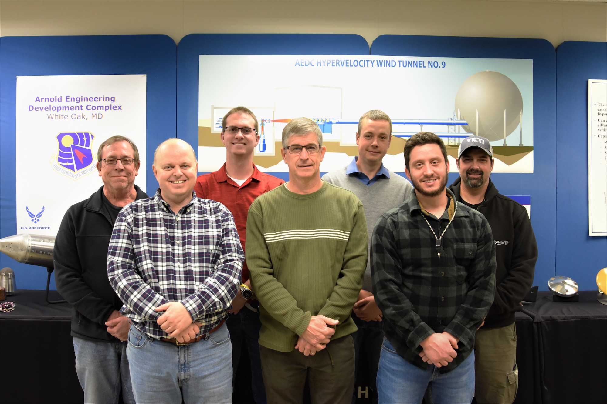 191218-F-GB367-0001: Test team members at AEDC Hypervelocity Wind Tunnel 9 in White Oak, Maryland, who were recently recognized for their outstanding customer satisfaction gather together for a group photo. The team discovered a missing test article component and facilitated the fabrication of this component to ensure a customer’s test could be completed without delay. Pictured from left are Bill Betz, Will Vodra, Cameron Butcher, John Lafferty, Dan Lewis, Alex Ratushny and Bernie Kefauver. (U.S. Air Force photo by A.J. Spicer)