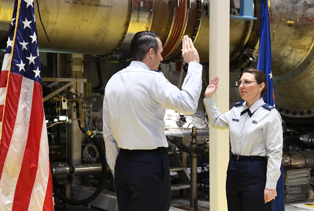 Lt. Col. Lane Haubelt, Arnold Engineering Development Complex Aeropropulsion director, administers the oath of office to newly-promoted Capt. Karlie Madden during a promotion ceremony Dec. 11 in an Arnold Engineering Development Complex test cell at Arnold Air Force Base, Tenn. (U.S. Air Force photo by Jill Pickett)