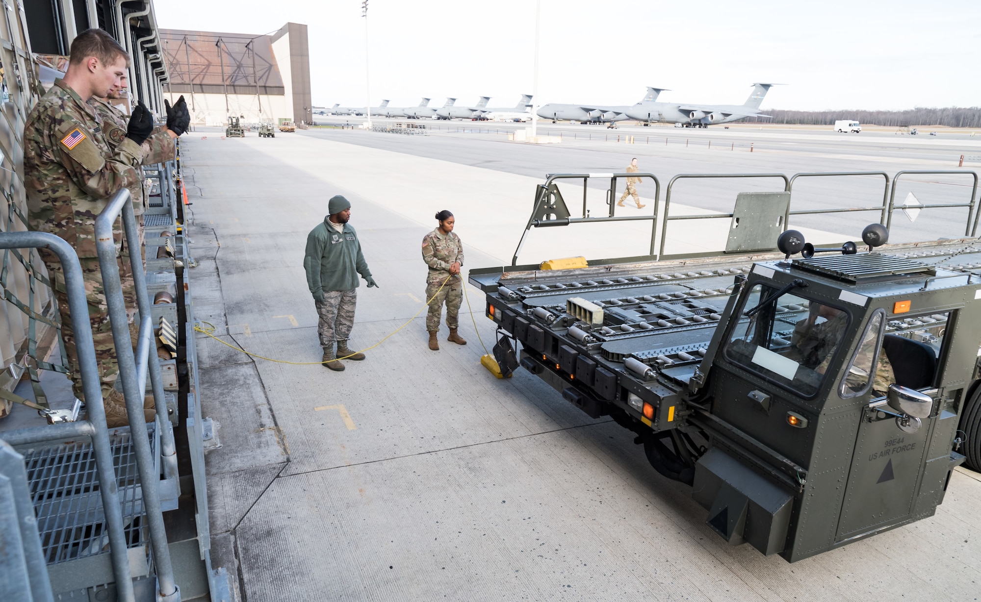 Members of the 436th Aerial Port Squadron instruct Army personnel on proper pallet loading onto a 60-ton K-loader Jan. 10, 2020, on Dover Air Force Base, Del. In a scheduled joint partnership training event, 16 members from the 622nd Movement Control Team, Joint Base Langley-Eustis, Va., came to Dover AFB for cargo and personnel processing training. (U.S. Air Force photo by Roland Balik)