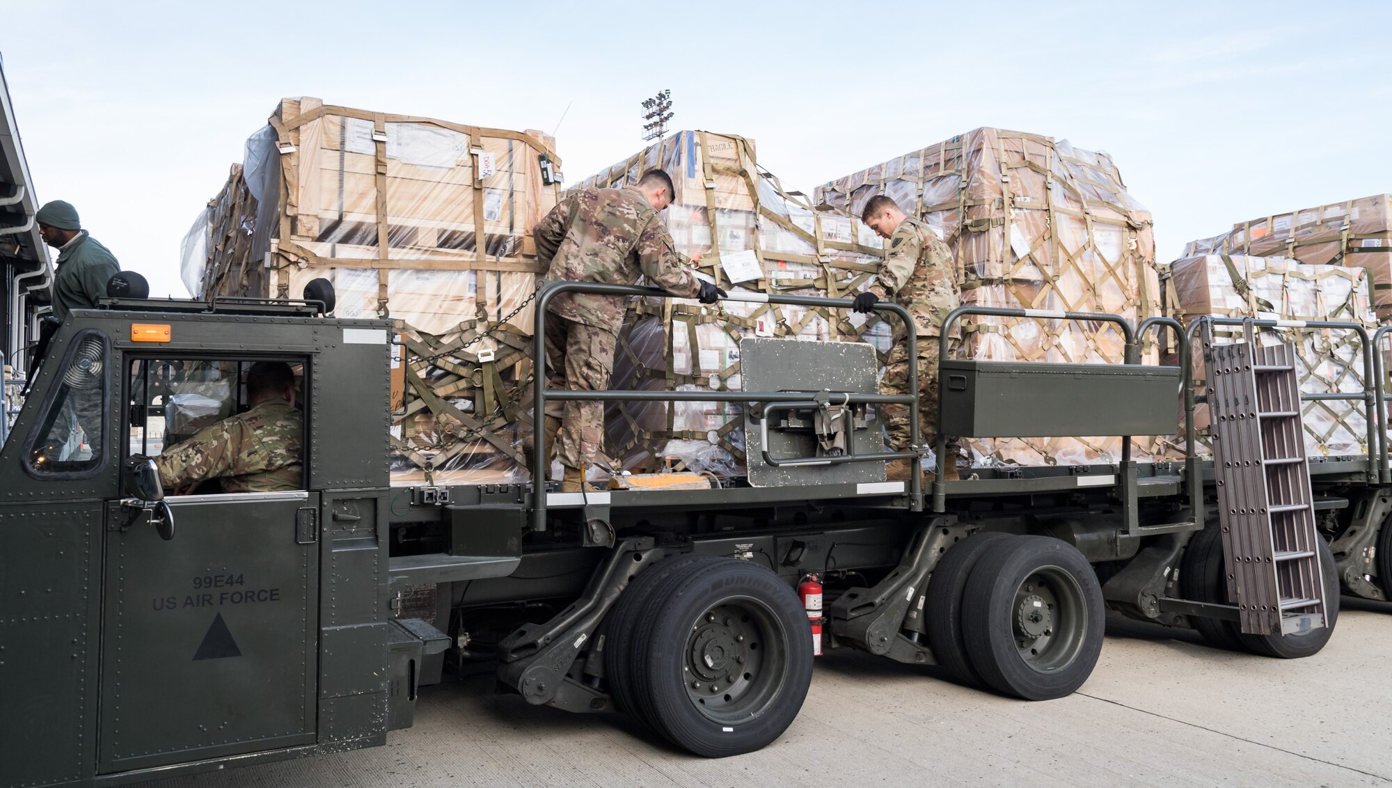Members of the 436th Aerial Port Squadron, Dover Air Force Base, Del., and Army’s 622nd Movement Control Team, Joint Base Langley-Eustis, Va., engage cargo pallet locks on a 60-ton K-loader Jan. 10, 2020, on Dover Air Force Base, Del. In a scheduled joint partnership training event, 16 members from the 622nd MCT came to Dover AFB for cargo and personnel processing training. (U.S. Air Force photo by Roland Balik)