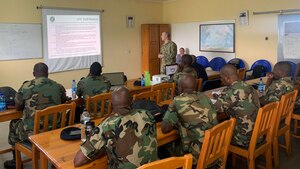 U.S. Air Force Master Sgt. Brandon Owens, 86th Mission Support Group Detachment 1 superintendent, Air Force Deployment Transition Center, briefs members of the Malawian air force on the U.S. Air Force’s decompression program at Lilongwe Air Base, Malawi, Jan. 16, 2020. Owen went to Malawi in support of the U.S. Air Forces Europe & Air Forces Africa force development team that has been working with the Malawian air force since 2018 to build partnership capability in the region. (U.S. Air Force photo by Capt. Korey Fratini)