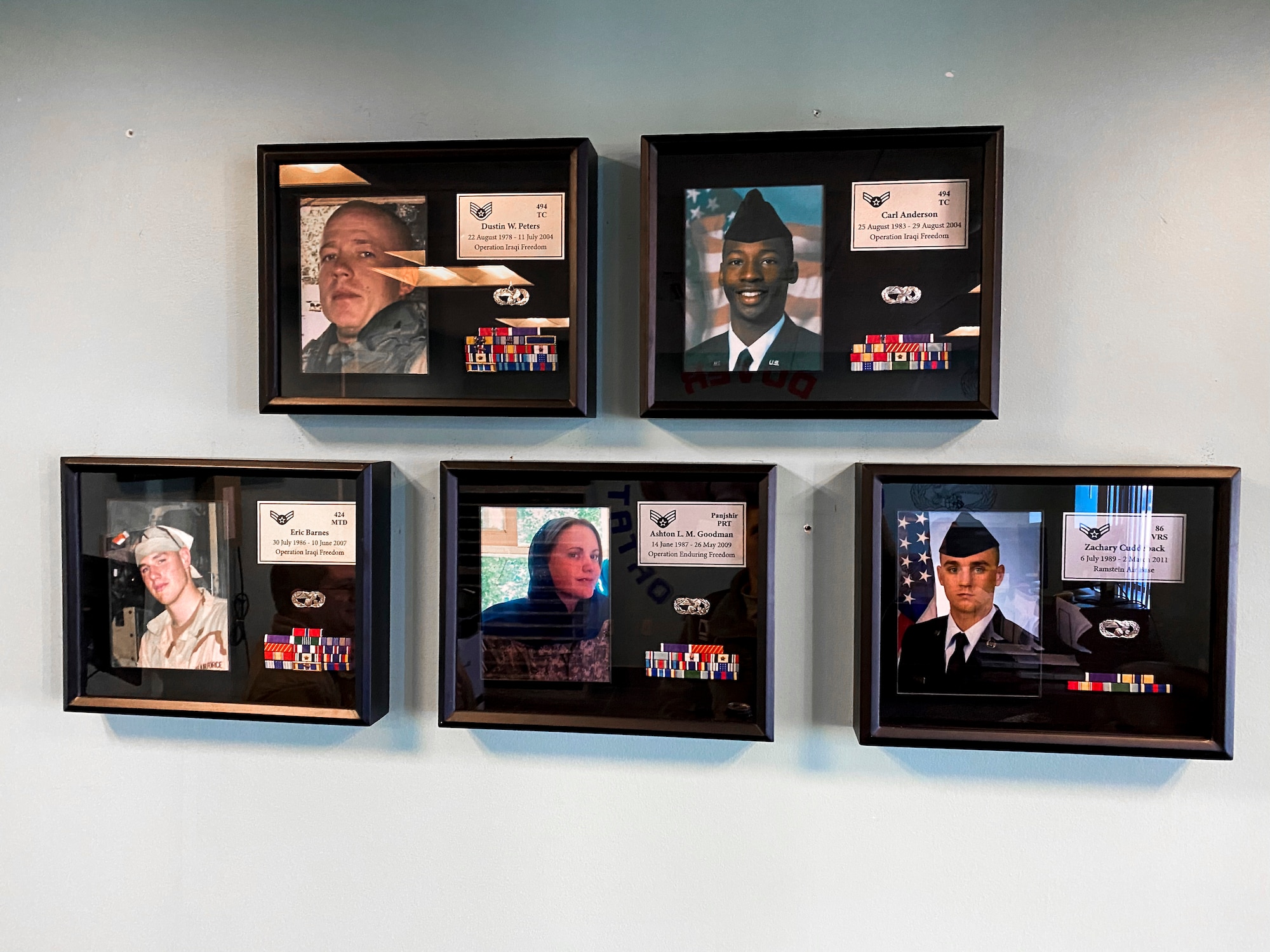 Shadow boxes hang on the wall as part of a 436th Logistics Readiness Squadron memorial, Jan. 17, 2020, at Dover Air Force Base, Del. The shadow boxes represent the fallen ground transportations operators killed in the line of duty. (U.S. Air Force photo by Senior Airman Christopher Quail)