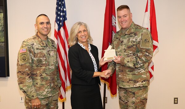 Daryl Puffinburger receives an award from TAD Commander Col. Christopher Beck during her graduation from the Division’s Leadership Development Program Tier 3.