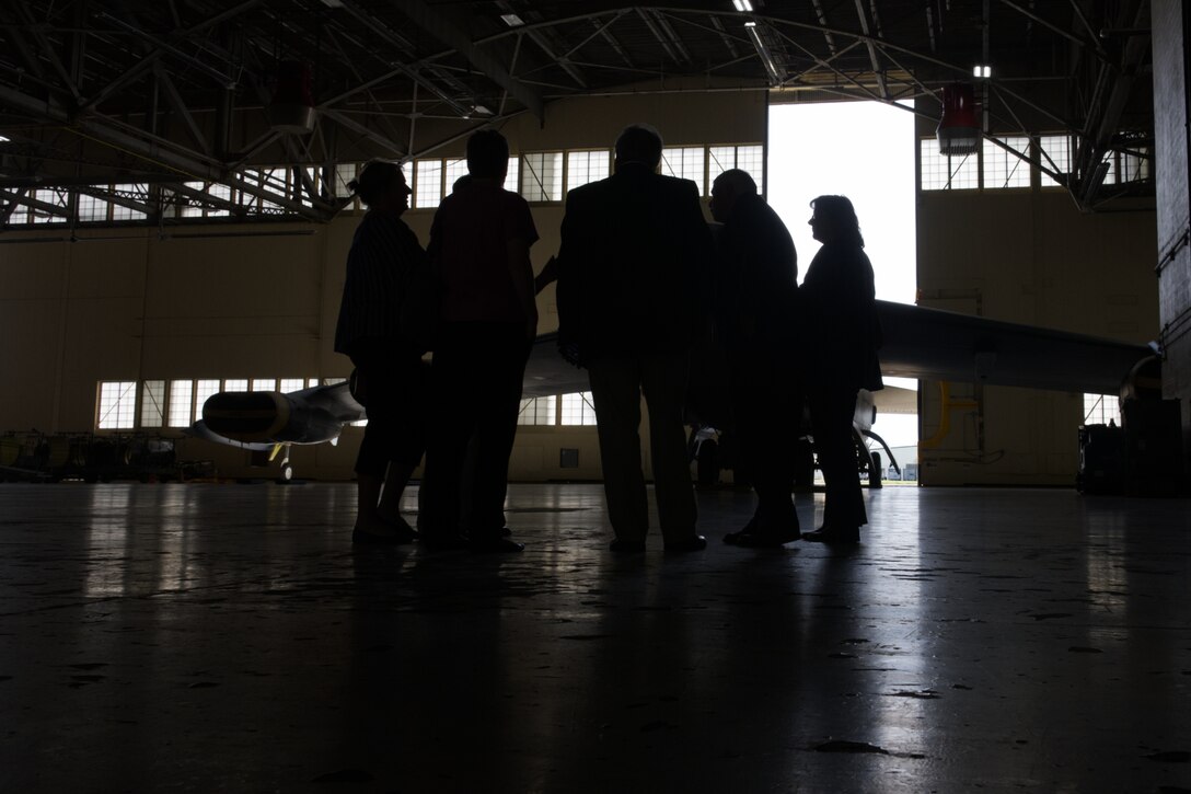 Silhouette of people standing outside a B-52