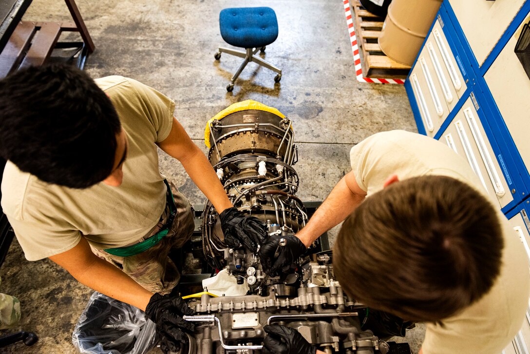 Staff Sgt. Leon Blomeley, right, 41st Helicopter Maintenance Unit craftsman, and Airman 1st Class Jonathan Flores, 41st HMU apprentice, work on removing a gearbox during a gearbox seal replacement on a spare HH-60G Pave Hawk engine Jan. 15, 2020, at Moody Air Force Base, Georgia. These repairs are performed to increase spare-part availability of HH-60G engines. This allows the 41st HMU to swiftly return aircraft to mission-capable status without delay. (U.S. Air Force photo by Senior Airman Erick Requadt)