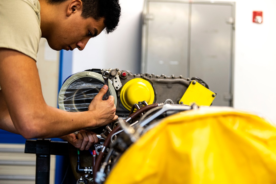 Airman 1st Class Jonathan Flores, 41st Helicopter Maintenance Unit apprentice, disconnects an oil scavenge tube during a gearbox seal replacement on a spare HH-60G Pave Hawk engine Jan. 15, 2020, at Moody Air Force Base, Georgia. These repairs are performed to increase spare-part availability of HH-60G engines. This allows the 41st HMU to swiftly return aircraft to mission-capable status without delay. (U.S. Air Force photo by Senior Airman Erick Requadt)