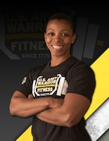 African American female crossing her arms in a gray tshirt with white and yellow lettering against a gray background with yellow and white stripe and faded warrior fitness team logo.