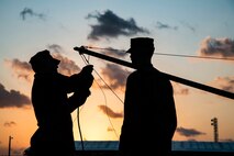 U.S. Marines Sgt. Chase Schmidt (left) and Cpl.  Jacob Worshan set up an antenna during a long distance, high-frequency communications training event held on Camp Schwab, Okinawa, Japan, Jan. 14, 2020. This training between 1st and 3rd Marine Division allowed both units to train in HF communications over the Pacific ocean. The training helps the units maintain a low electromagnetic signature that is virtually impervious to meaconing, jamming, and interference, which allows for distributed operations without detection in the operating environment. Schmidt, a native of Gulf Breeze, Fla., and Worshan, a native of Calhoun, Ga., are radio operators currently under 4th Marine Regiment, 3rd Marine Division. (U.S. Marine Corps photo by Lance Cpl. Christian Ayers)
