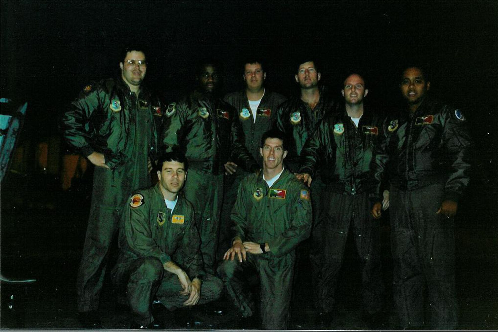 Photo of Airmen posing on runway.