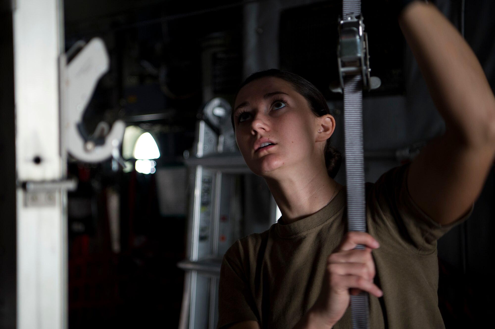 A U.S. Air Force medical technician assigned to the 379th Expeditionary Aeromedical Evacuation Squadron configures the inside of a C-130 Hercules during an aeromedical evacuation mission at Al Udeid Air Base, Qatar, Jan. 3, 2020.