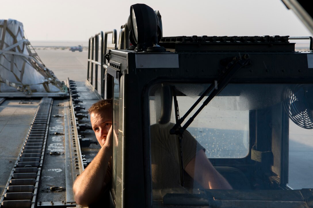 A U.S. Air Force aerial porter assigned to the 8th Expeditionary Air Mobility Squadron loads cargo into a C-130 Hercules during an aeromedical evacuation mission at Al Udeid Air Base, Qatar, Jan. 3, 2020.