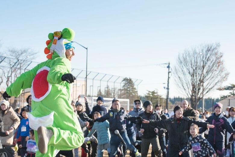 A fitness instructor leads race participants in a warmup before the run during the 39th Annual Frostbite Run, Jan.19, 2020, at Yokota Air Base, Japan.