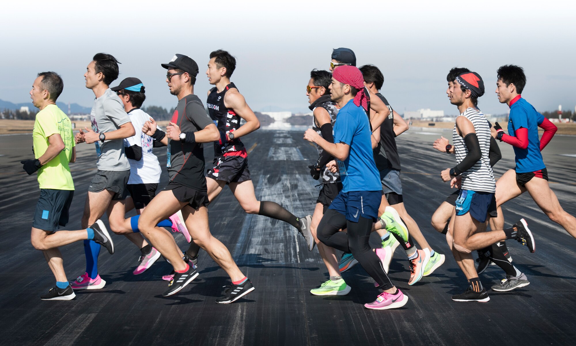 Athletes in a Half Marathon cross the runway during the 39th Annual Frostbite Run, Jan.19, 2020, at Yokota Air Base, Japan.