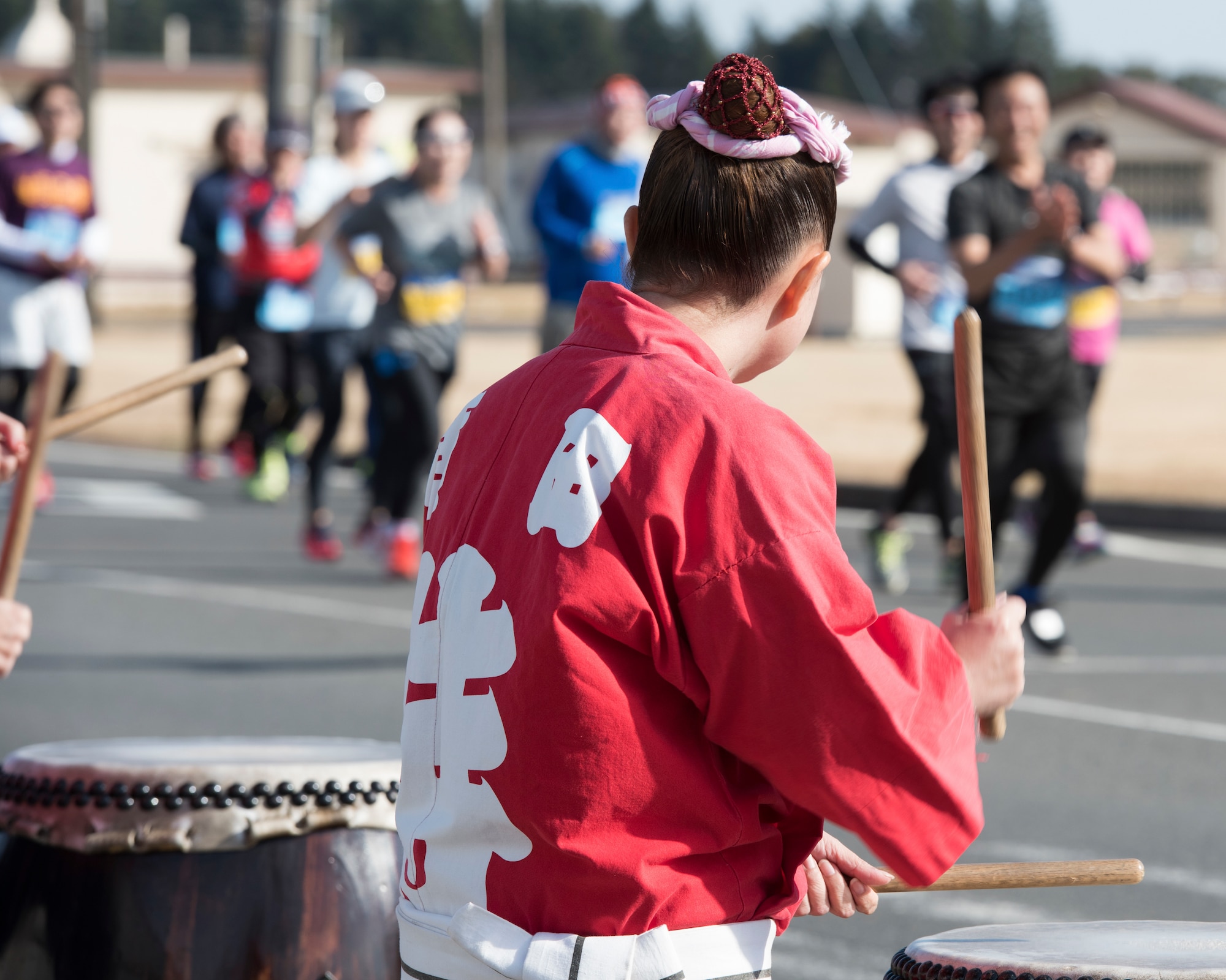 Members of the Samurai Taiko Drum Team cheer the runners during the 39th Annual Frostbite Run, Jan.19, 2020, at Yokota Air Base, Japan