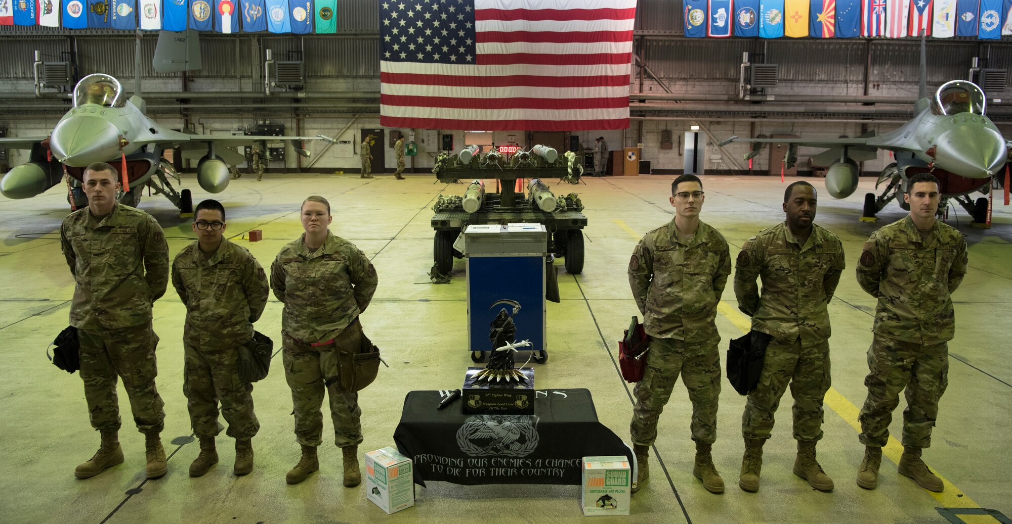 Load crews are not only tested on how fast they can load weapons onto an F-16 Fighting Falcon but also on their individual dress and appearance, written knowledge and organization of tools