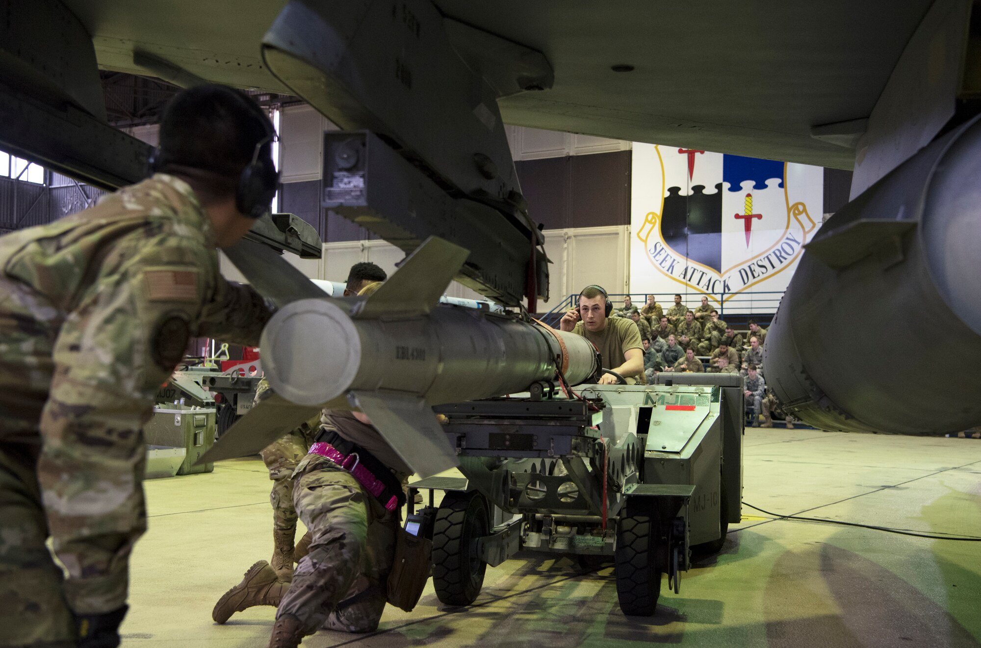 The competition required two teams of three Airmen to load weapons onto the wings of an F-16 Fighting Falcon as quickly and accurately as possible