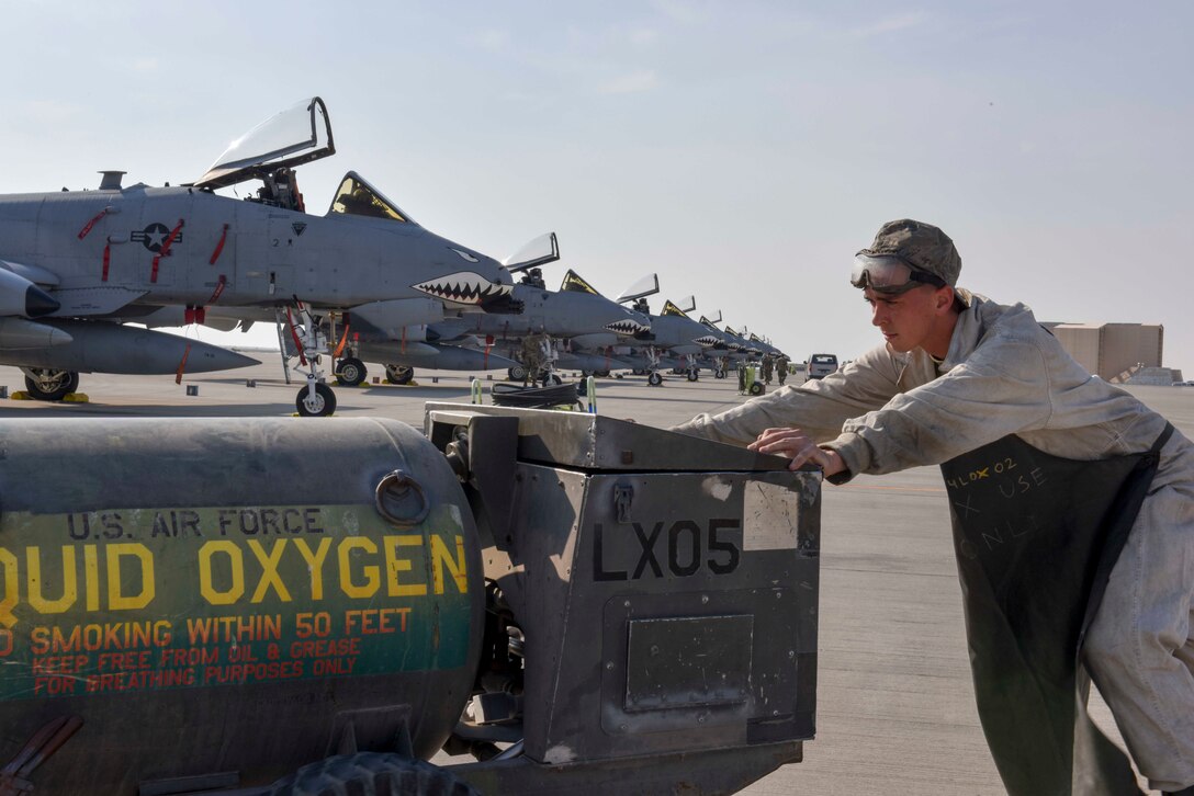 An Airman with the 74th Fighter Squadron pushes a liquid oxygen cart toward an A-10 Thunderbolt II at Al Udeid Air Base, Qatar on Jan. 16, 2020. The A-10 Thunderbolt II provides close air support and has excellent maneuverability at low air speeds and altitude, and is a highly accurate and survivable weapons-delivery platform. (U.S. Air Force photo by Tech. Sgt. John Wilkes)