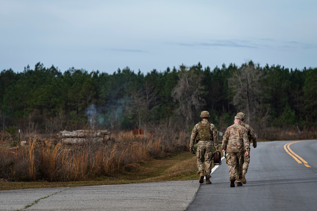 A photo of Airmen walking to the scene of a UXO