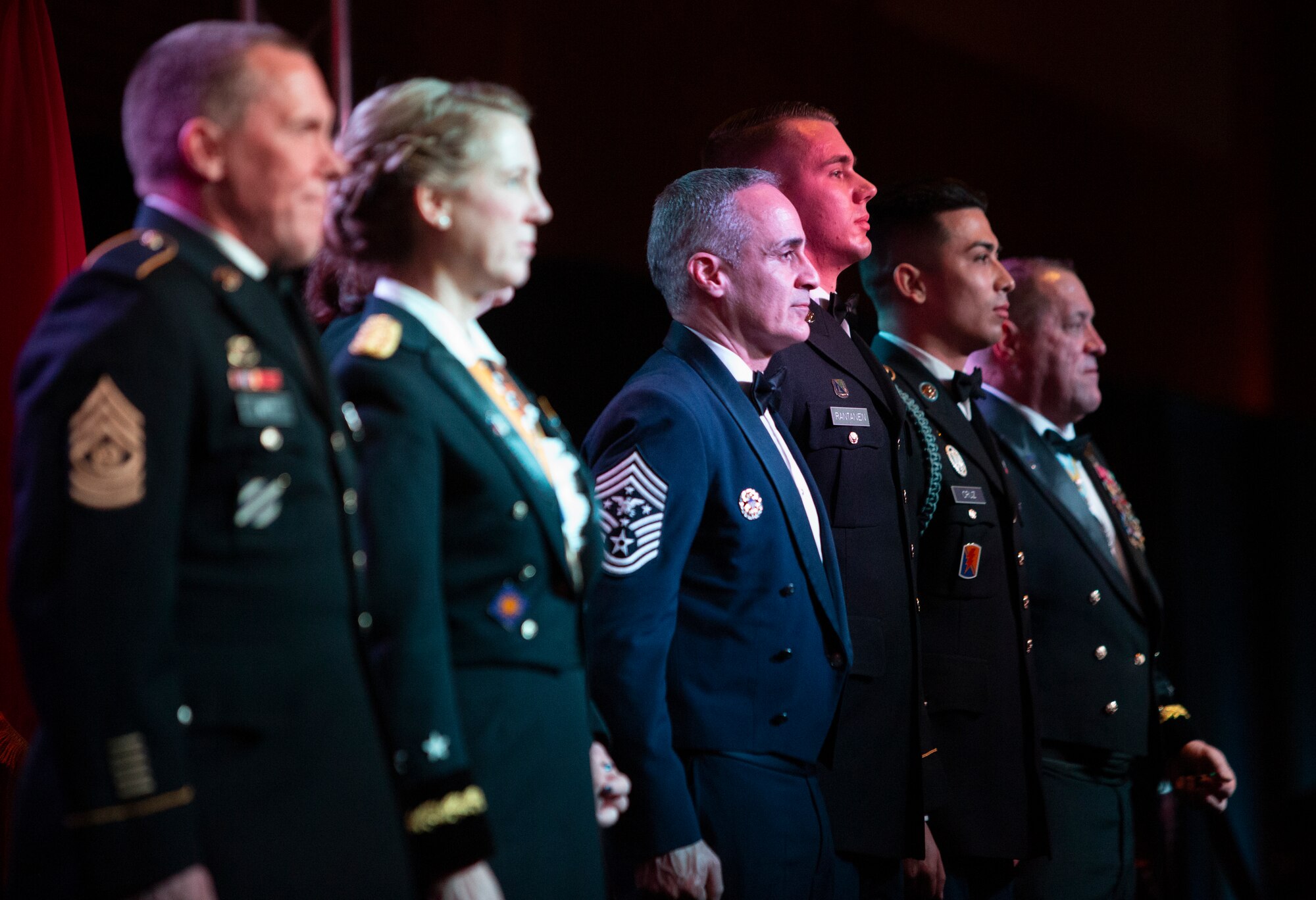 Senior Enlisted Advisor to the Chairman of the Joint Chiefs of Staff Ramón “CZ” Colón-López, center, stands at attention as medal citations are read for U.S. Army Sgt. Alec Rantanen, third from right, and Spc. Jesus Cruz, second from right, during the California Military Department Service Member of the Year Banquet, Jan. 18, 2020, in San Diego. The banquet recognized the best enlisted soldiers, airmen and sailors in the California Army National Guard, California Air National Guard and California State Guard. Rantanen earned Noncommissioned Officer of the Year honors for the California Army National Guard and Cruz was named Soldier of the Year. At right is Maj. Gen. David S. Baldwin, Adjutant General of the California Military Department.
