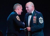 U.S. Air Force Command Chief Master Sgt. Thomas L. James, Senior Enlisted Advisor to the Adjutant General of the California Military Department, right, presents a custom California pararescue t-shirt to Senior Enlisted Advisor to the Chairman of the Joint Chiefs of Staff Ramón “CZ” Colón-López, left, after SEAC's keynote remarks during the California Military Department Service Member of the Year Banquet, Jan. 18, 2020, in San Diego. SEAC, himself a pararescueman, spent the day meeting with California National Guard Soldiers and Airmen during the Cal Guard's annual leadership conference. The California Air National Guard is home to the 129th Rescue Wing which has recorded more than a thousand lives saved.