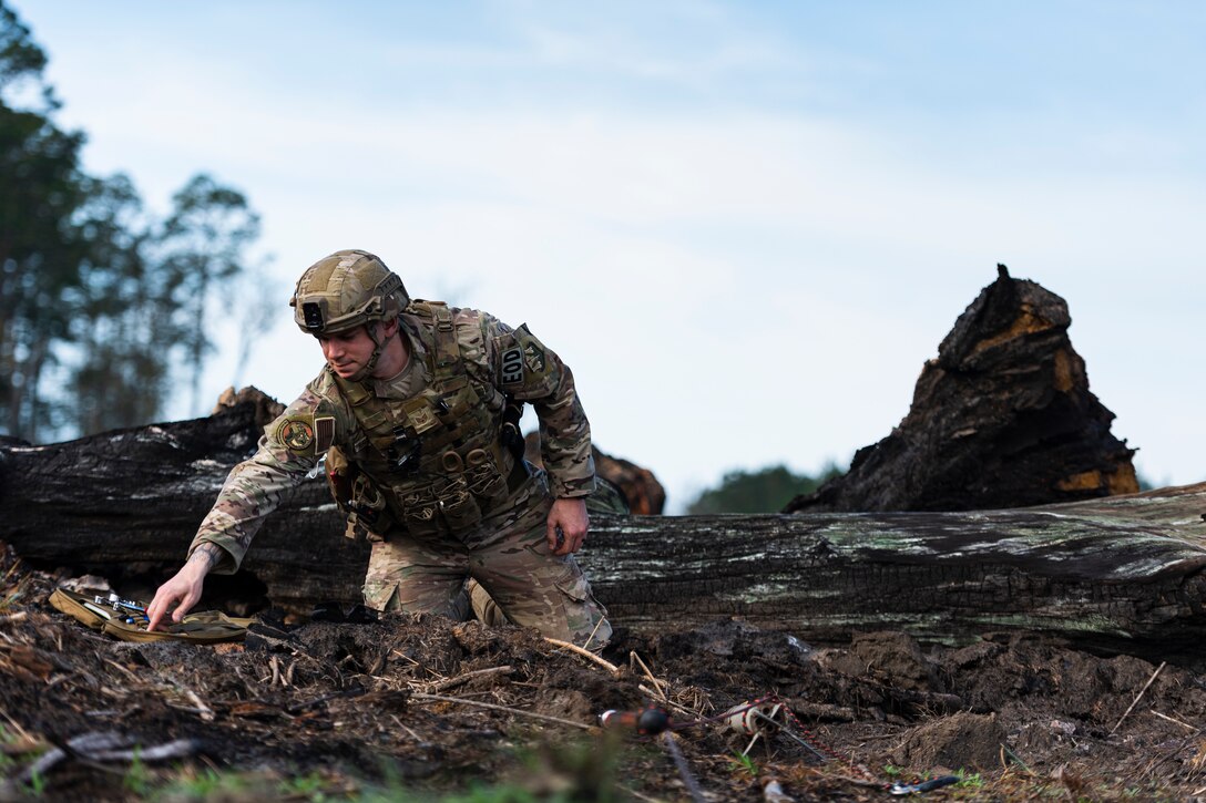 A photo of an Airman choosing a tool from a kit