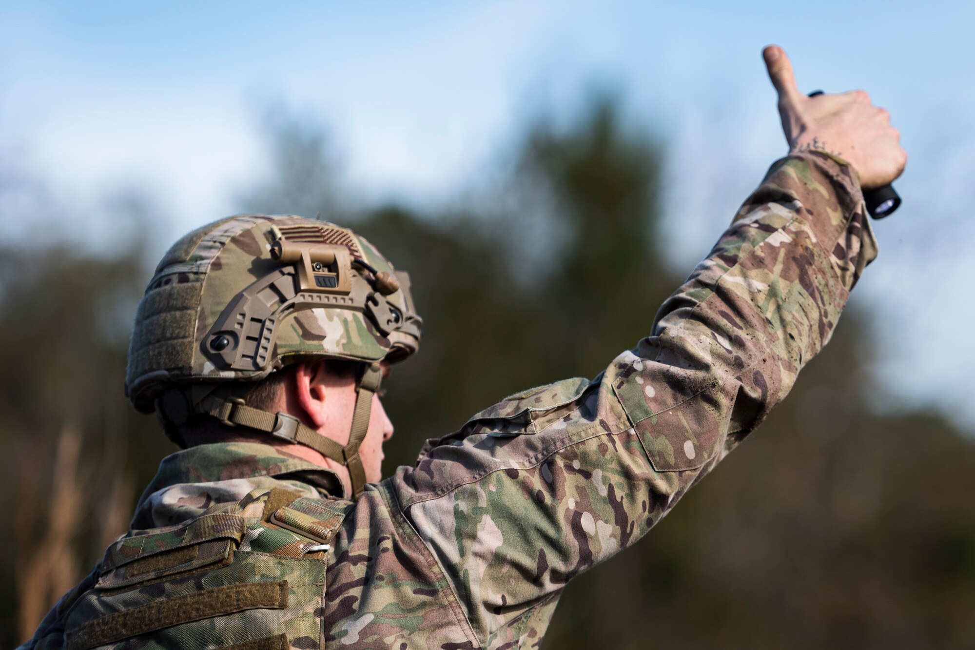 A photo of an Airman giving a hand signal