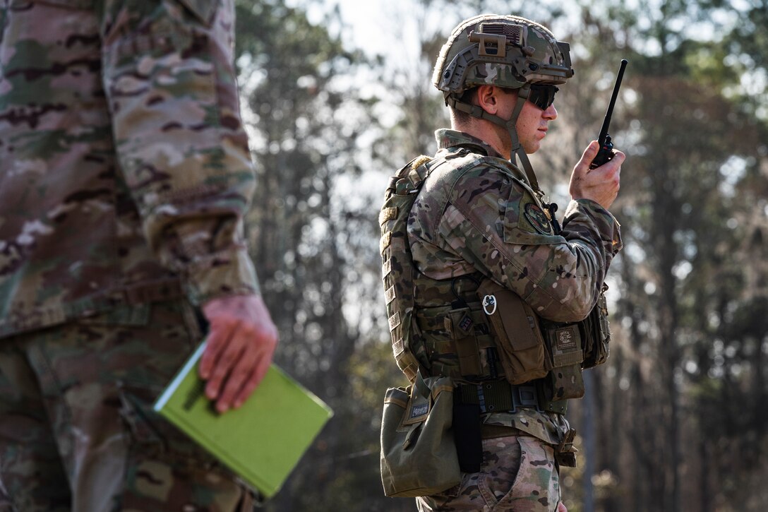 A photo of an Airman using a radio