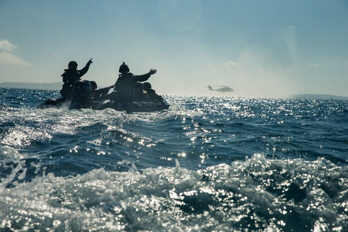 Marines move into position to begin a simulated beach raid at Kin Blue, Okinawa, Japan, Dec. 17.