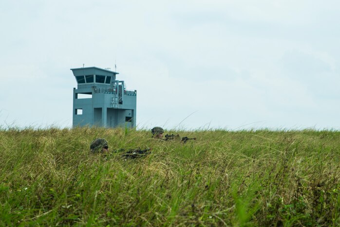 Marines provide security during a simulated airfield seizure at Ie Shima Training Facility, Okinawa, Japan, Dec. 9.