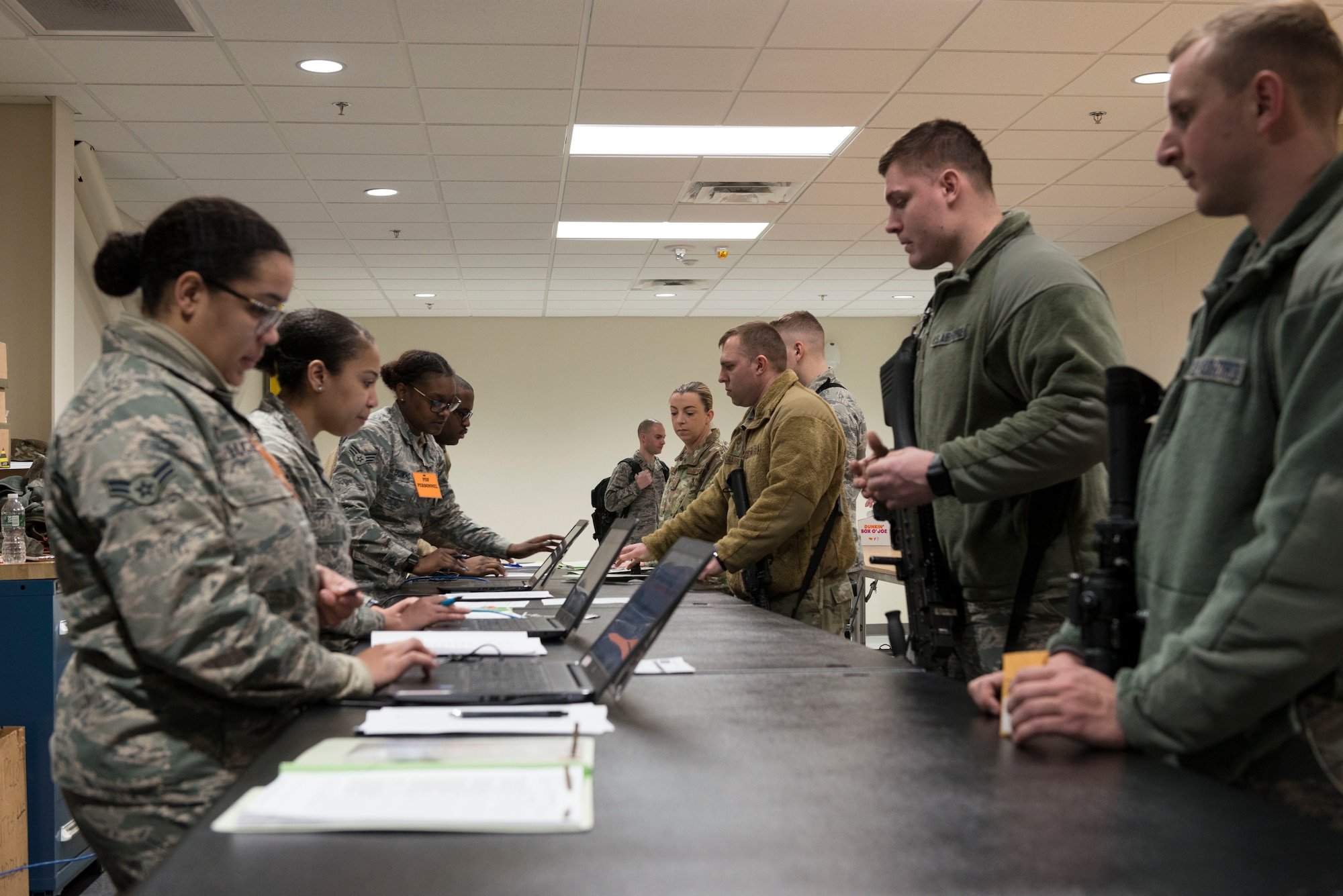 U.S. Air Force Airmen, assigned to the Logistics Readiness Squadron, 103rd Airlift Wing, Connecticut Air National Guard, work to in-process 103rd Security Forces Squadron Airmen Jan. 5, 2020, at Bradley Air National Guard Base, East Granby, Conn. The 103rd AW conducted a base-wide deployment exercise to enhance Airmen’s readiness for rapid mobility. (U.S. Air National Guard photo by Airman 1st Class Chanhda Ly)