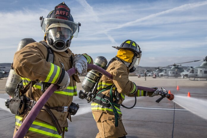 U.S. Marines man a hose during handline drills on the flightline at MCAS Camp Pendleton, Calif., Jan. 14.